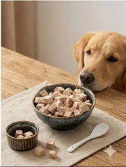 PawDry Freeze-Dried Duck Bites Pets Treats 100g in a bowl with a golden retriever dog looking at the treats.