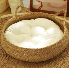 Woven seagrass pet bed with plush white cushion, ideal for cats and dogs