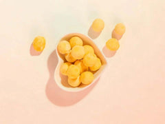 PawDry Freeze-Dried Quail Egg Yolk 100g in a heart-shaped bowl on a pastel background.