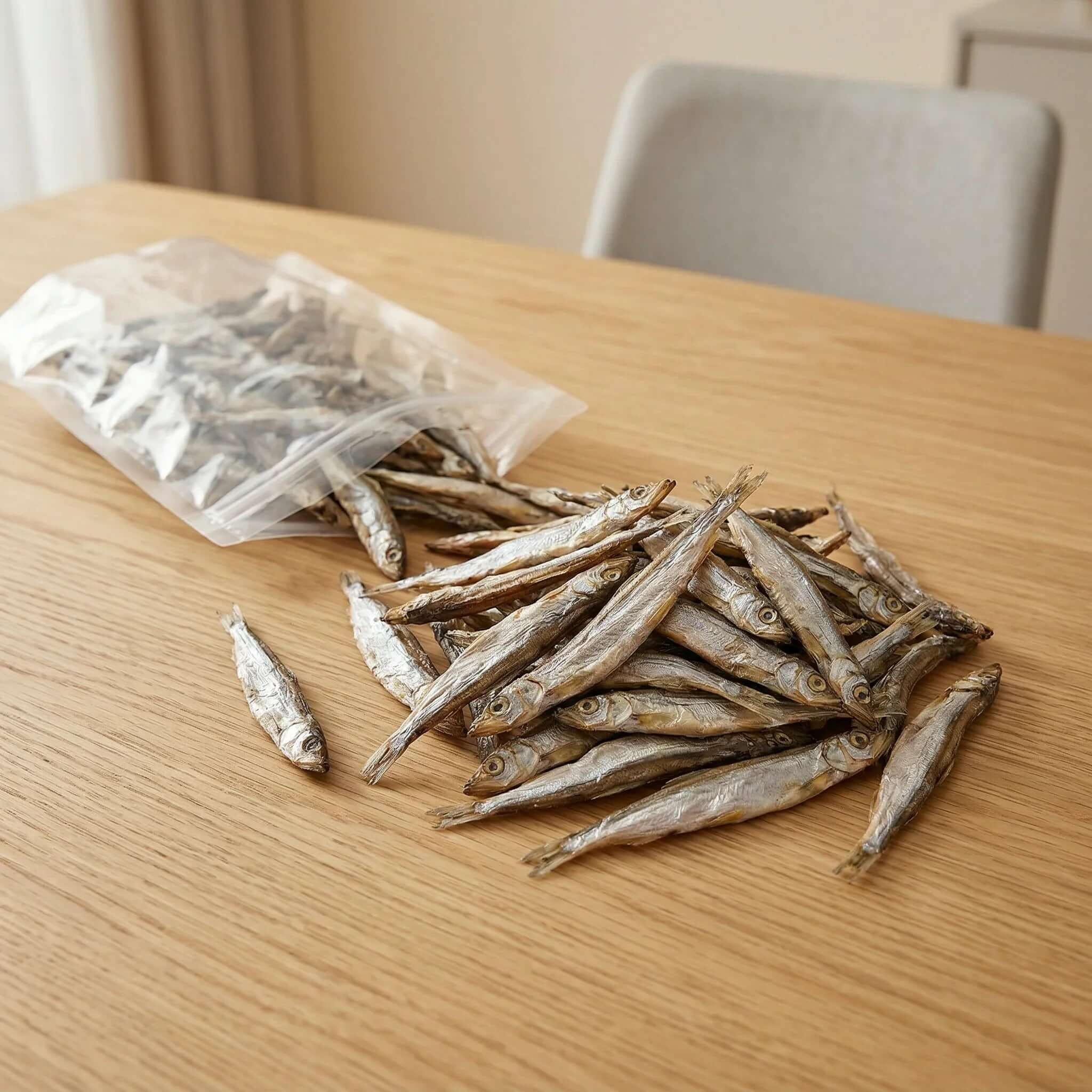 PawDry Freeze-Dried Whole Capelin 100g - Lean & High Protein, natural fish treats for pets on a wooden table.
