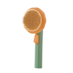 AIWO Pet grooming brush with orange bristle head and green handle on a white background