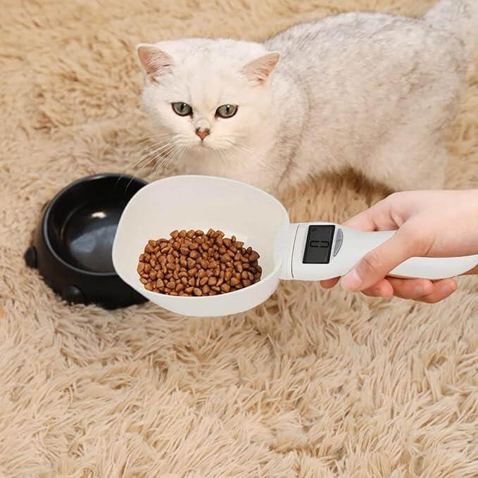 Digital pet food scoop measuring kibble for cat, ideal for precise feeding and pet care