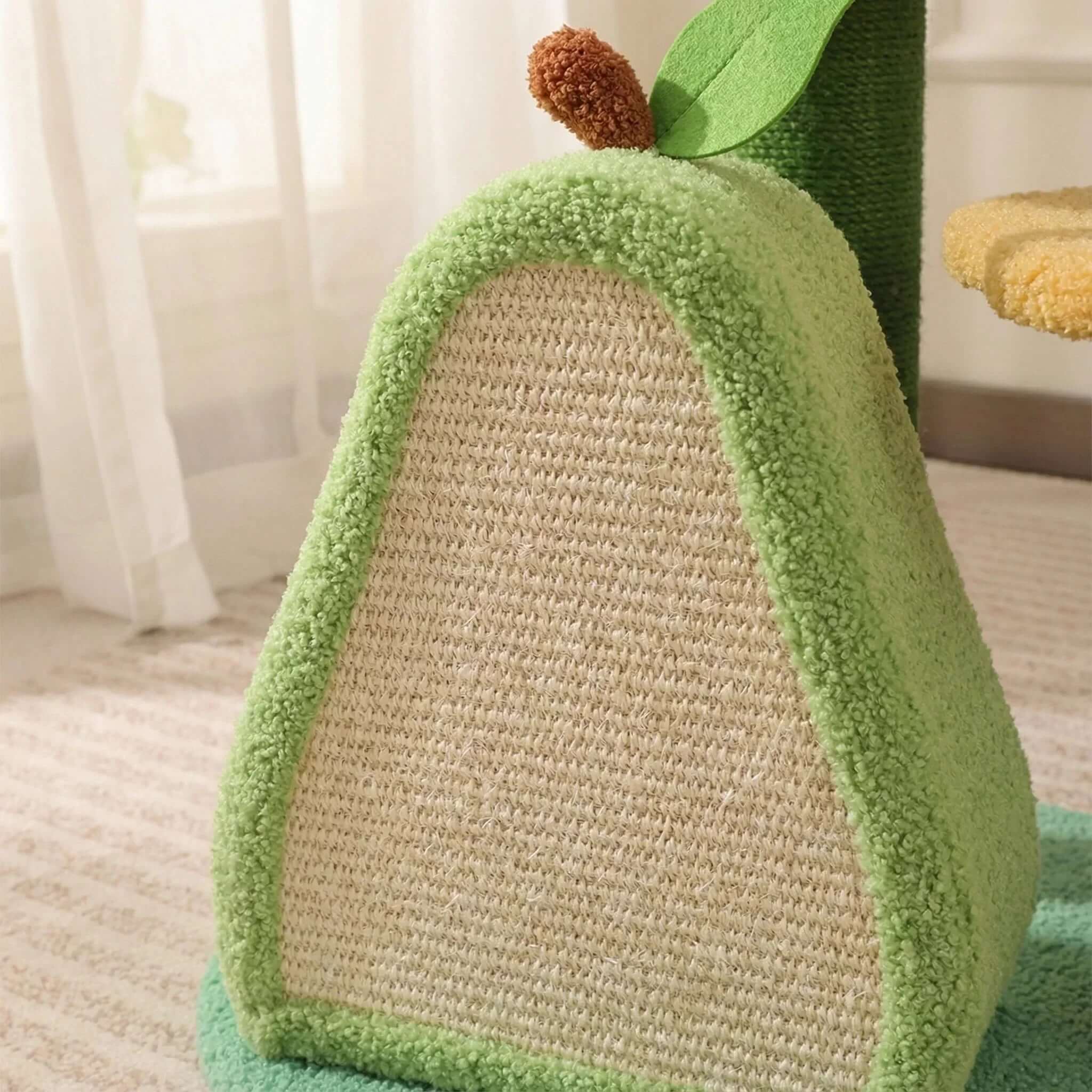 Avocado-shaped cat scratcher with green plush exterior and sisal scratching surface, perfect for indoor cats.