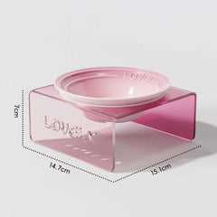 Pink pet bowl with measurements on a light gray background