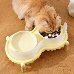 Fluffy ginger cat eating from elevated dual pet bowl with 15cm food dish and water bowl on wooden floor