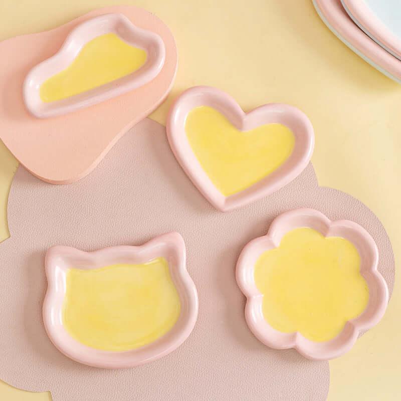 Cute pink and yellow ceramic pet bowls in heart, cat, and flower shapes for cats and dogs
