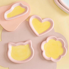 Cute pink and yellow ceramic pet bowls in heart, cat, and flower shapes for cats and dogs