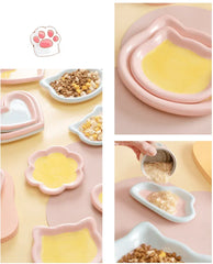 Cute pastel pet bowls in cat, heart, and flower shapes holding dry and wet food for cats and dogs