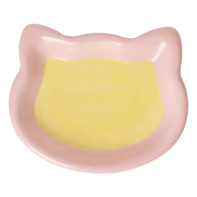 Pink cat-shaped ceramic pet bowl with yellow interior, ideal for cats and dogs