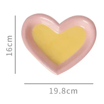 Pink heart-shaped pet bowl with yellow interior, 16cm height, 19.8cm width, for cats or dogs