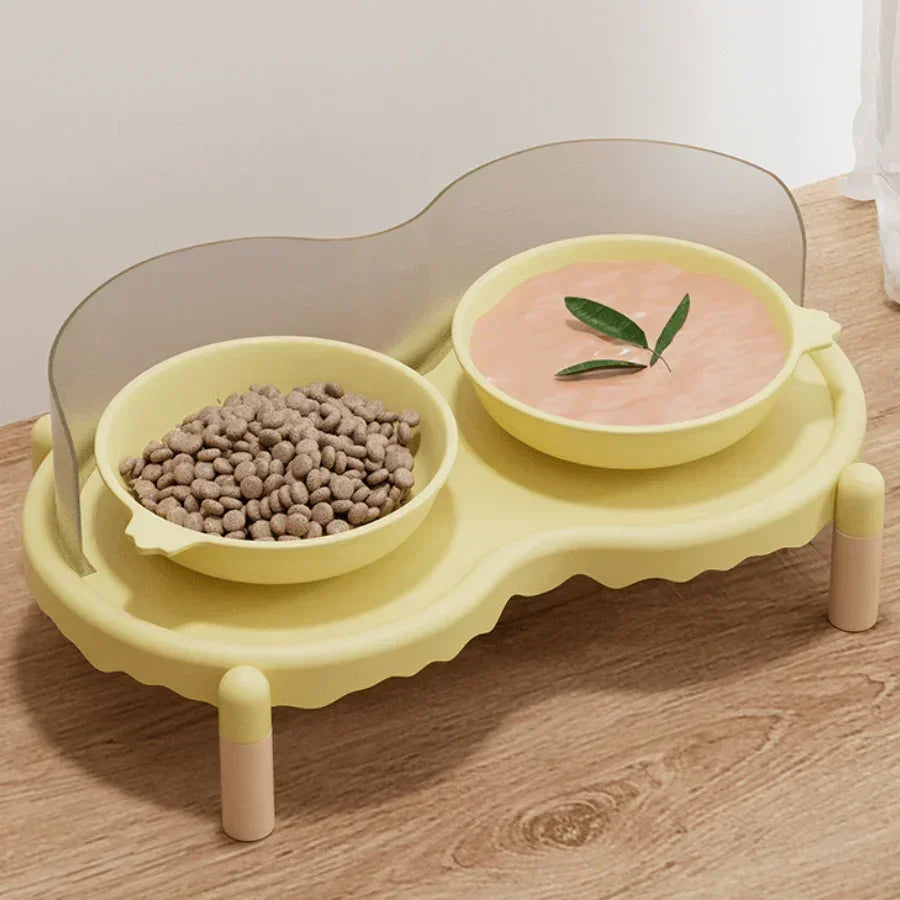 Yellow elevated pet feeder with two bowls: dry kibble and wet food, on wooden floor