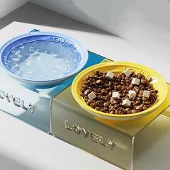 Pet food and water bowl set with 'Lovely' branding on a white surface.