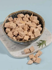 PawDry Freeze-Dried Duck Bites Pets Treats 100g in a bowl, natural grain-free dog and cat snacks.