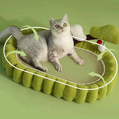 Grey cat lounging on green textured cat bed with plush sides and interactive toy, ideal for cozy pet comfort.