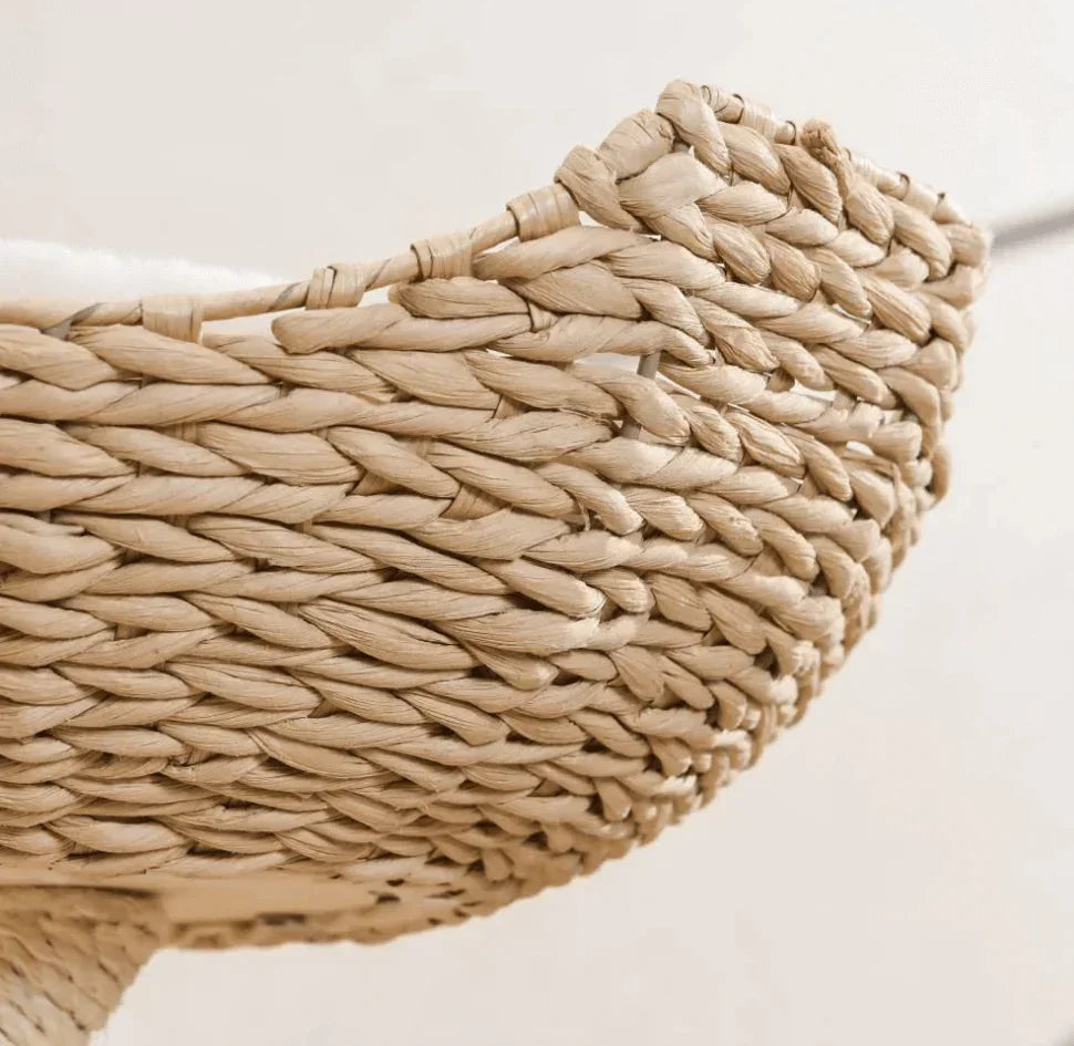 Handwoven natural fiber pet bed with soft cushion, ideal for cats and dogs