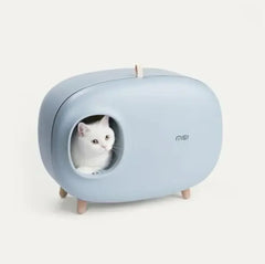 White cat in modern blue cat bed with wooden legs, stylish pet furniture for cats