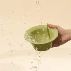 Green pet bowl being filled with water, ideal for cats and dogs