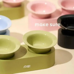Modern elevated pet bowls in pastel green, pink, blue, and black for cats and dogs, stylish and practical feeding setup