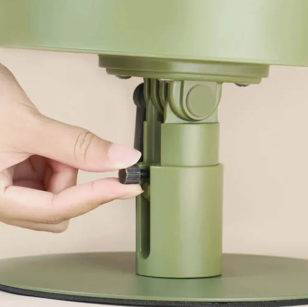 Hand adjusting height of olive green pet bed base with knob