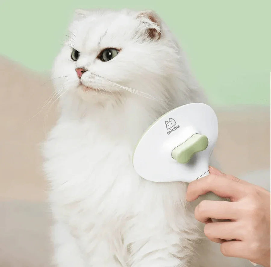 Michu Round-Head Grooming Dog Cat Brush in use on a fluffy white cat's fur for a smooth grooming experience.
