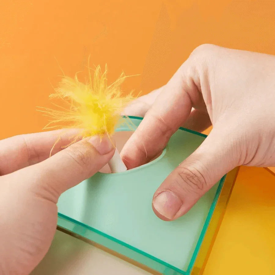Close-up of hands interacting with the Michu Interactive Feathered Rechargeable Automatic Cat Toy Box's feather toy.