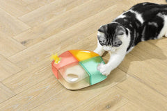 Michu Interactive Feathered Rechargeable Automatic Cat Toy Box with a cat playing with it on wooden floor.