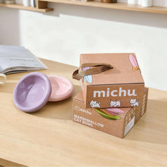 Michu marshmallow cat bowls in purple and pink with packaging on wooden table