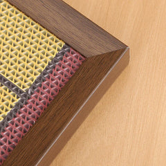 Wooden-framed pet scratcher with yellow, gray, and red textured panels for cats