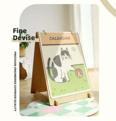 Cute cat calendar on wooden stand, perfect for pet lovers' home decor with playful design