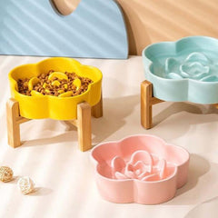 Flower-shaped pet bowls in yellow, pink, and blue with wooden stands for cats and dogs