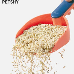 Orange cat litter scoop with blue handle scooping clumping cat litter