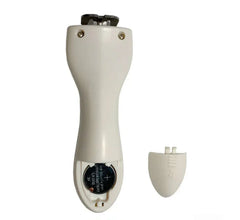 White pet nail clipper with battery compartment open, showing CR2032 battery and safety guard