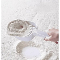 White cat litter scoop lifting clumps from litter box, ideal for cat owners