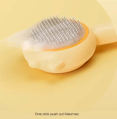 Pet grooming brush with metal bristles on a yellow background