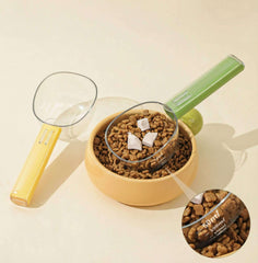 Dopamine Series 2-in-1 Pet Food Scoop with graduated measuring cup and bag sealing clip over pet food bowl.