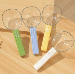 Dopamine Series 2-in-1 Pet Food Scoop in vibrant colors green, blue, yellow, and white on a wooden surface.