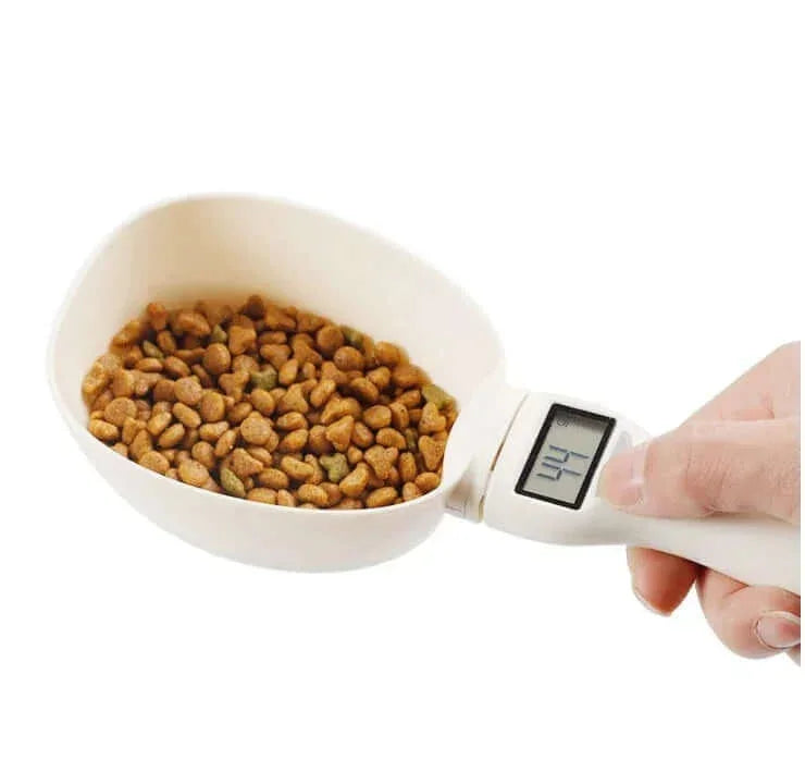 Digital pet food scoop measuring kibble for dogs or cats with precise weight display