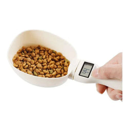 Digital pet food scoop measuring kibble for dogs or cats with precise weight display