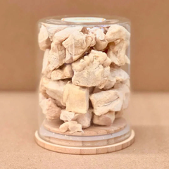 Freezy Paws Freeze Dried Cat Treats Chicken Breast with Colostrum 80g in a clear jar on a wooden base.