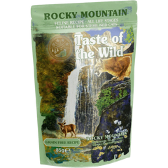 Taste of the Wild Grain-Free Rocky Mountain Feline Recipe - Chunks in Gravy 85g x 12 Pack, wet cat food pouch in natural setting.