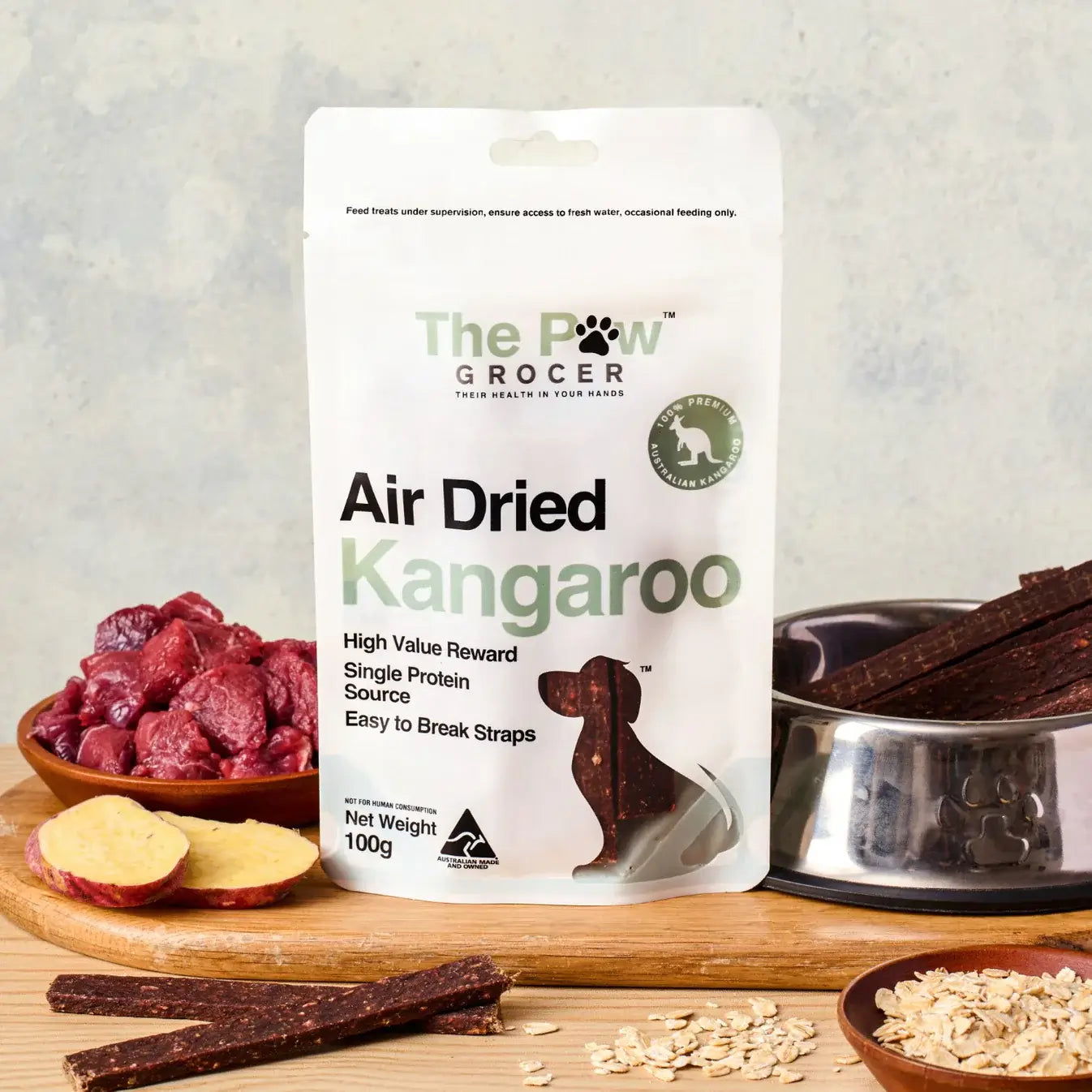 THE PAW GROCER Air-Dried Kangaroo Dog Training Straps 100g packaging with dog treats and ingredients.