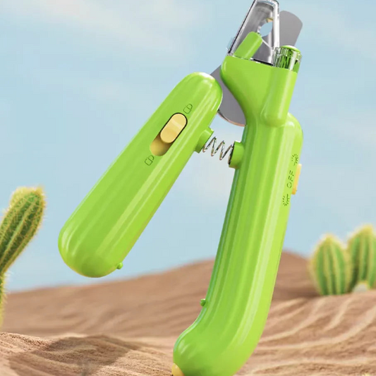 Green pet nail clipper on a desert background with cacti