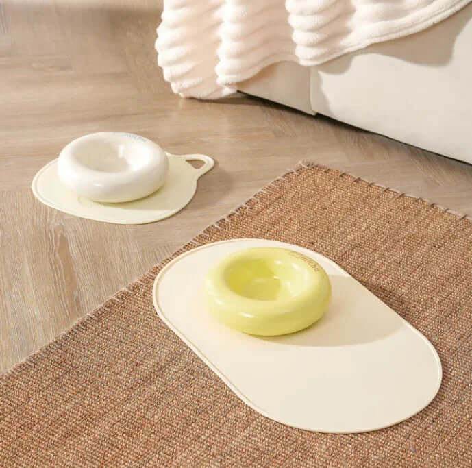 Michu Ceramic Cat Bagel Bowl – Anti-Whisker Wide Shallow Pet Food Bowl Rainbow Colours in white and yellow on a mat.