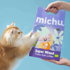 Michu Mixed Clumping Tofu Cat Litter Lite 2.5kg/6L – Flushable& Cost-efficient package being handled by a cat.