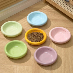 Michu Wide and Shallow Ceramic Pet Bowl in various pastel colors with dry cat food inside