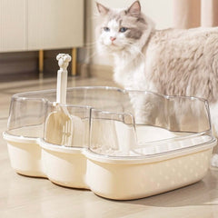 Transparent Semi-Enclosed Large Cat Litter Tray with Scoop placed next to a cat in a bright room.