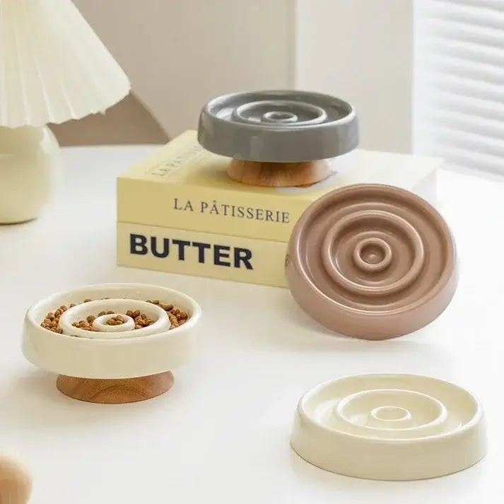 Stylish ceramic slow feeder bowls for dogs and cats with wooden bases, ideal for mindful pet feeding