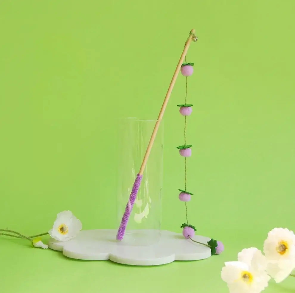 Purple cat wand toy with felt berries and bell, perfect for playful cats and stylish pet supplies.