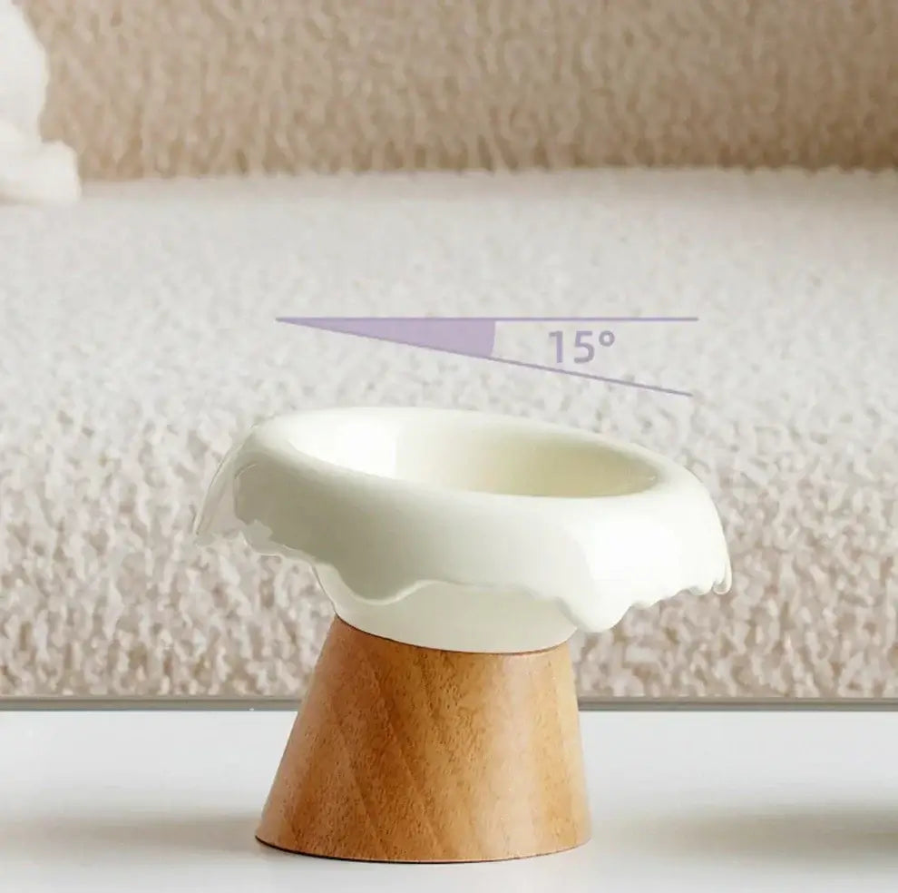 Elevated ceramic pet bowl with 15° tilt on wooden stand, designed for cat and dog comfort.