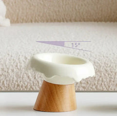 Elevated ceramic pet bowl with 15° tilt on wooden stand, designed for cat and dog comfort.